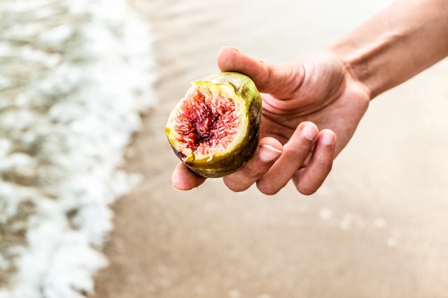 Man holding a fig