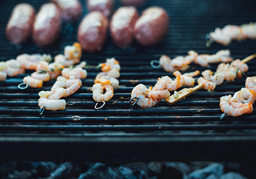  Close up of prawn skewers on a barbecue.