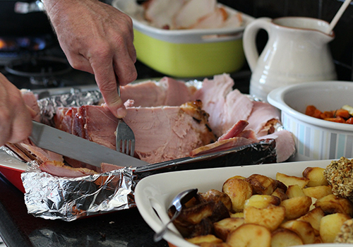 Christmas ham leftovers being sliced.