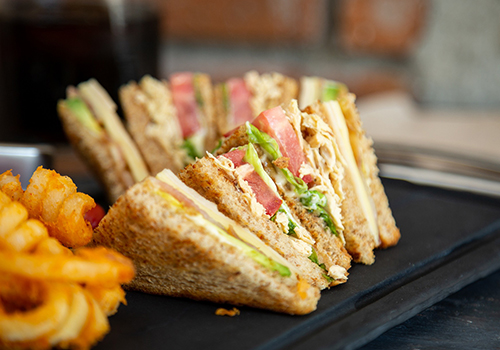 Close up of ham club sandwiches.