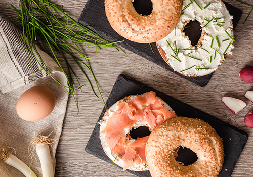 Cream cheese bagel with smoked salmon, dill, spring onion and chives.