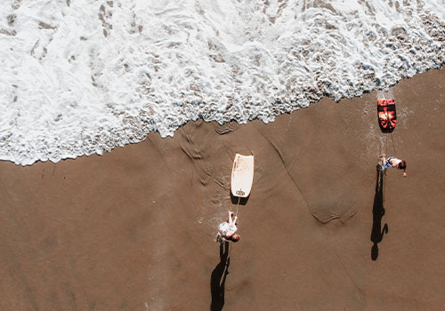 Overhead photo of people boogie boarding