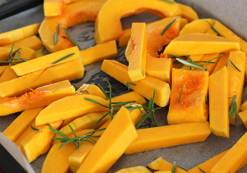 Cut pumpkin on oven tray