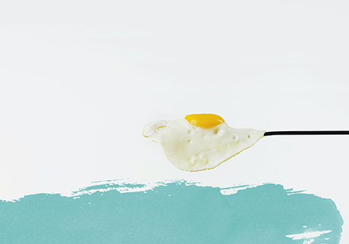 Fried egg on a blue background